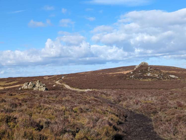Shepherd's rock with cairn on path and rocky crown shape formation